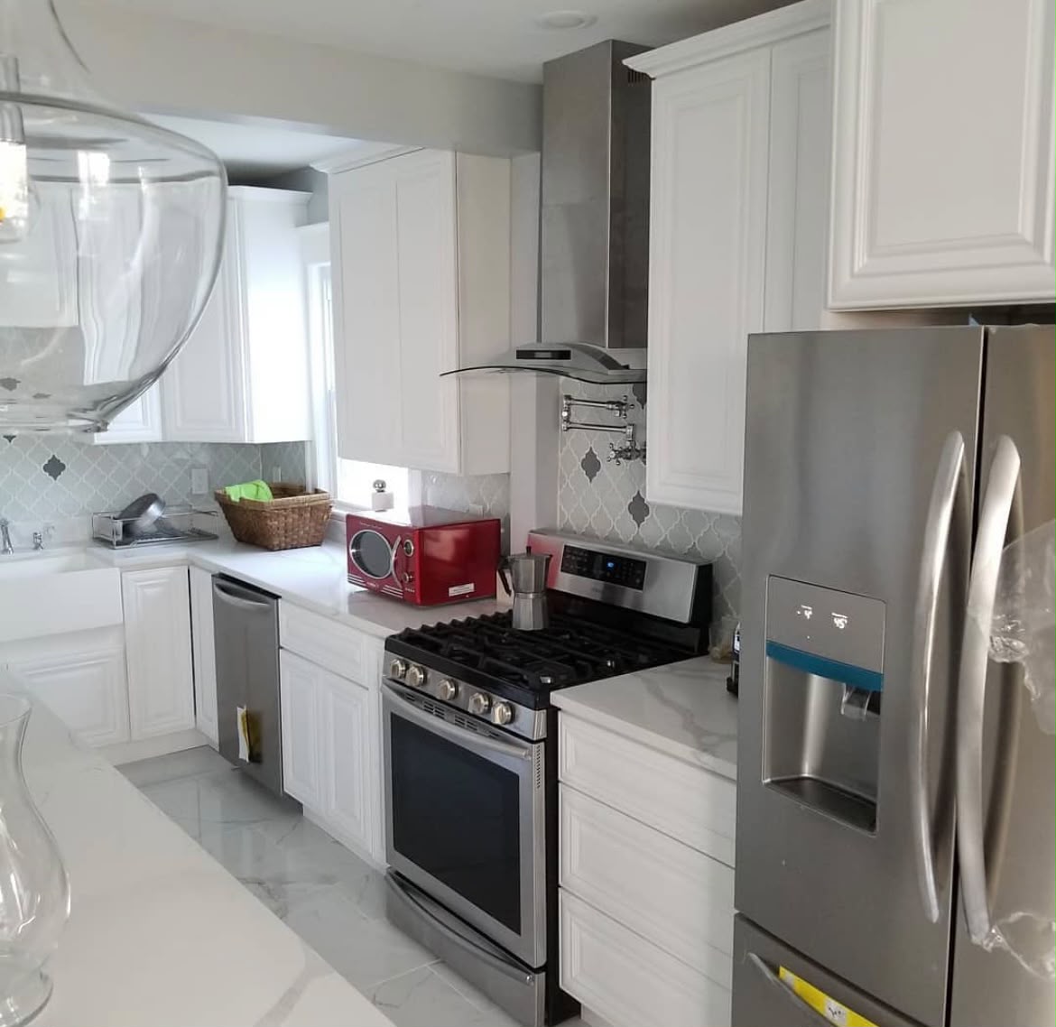 White kitchen cabinetry and tile detail